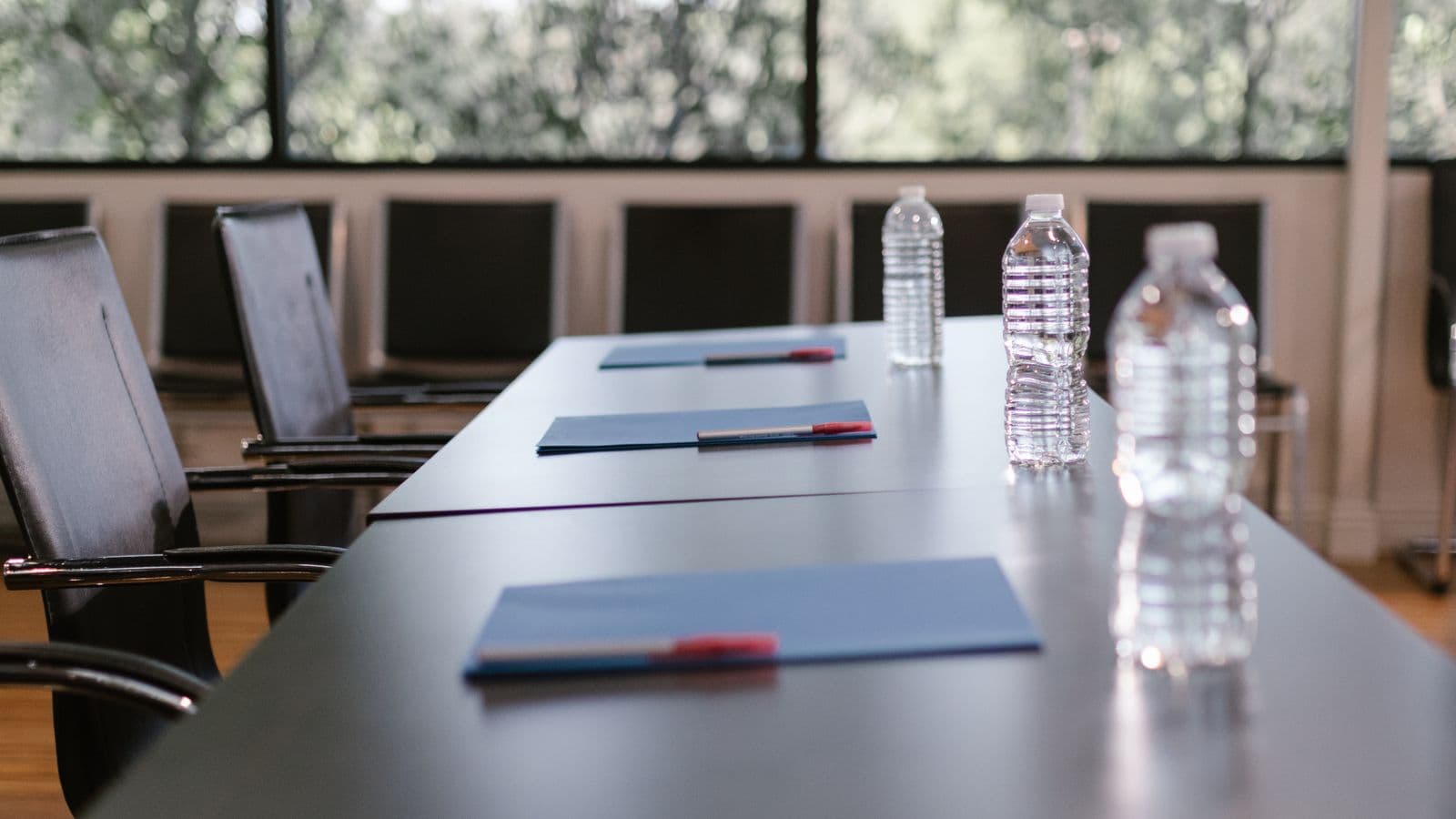 Conference table prepared with folders and water
