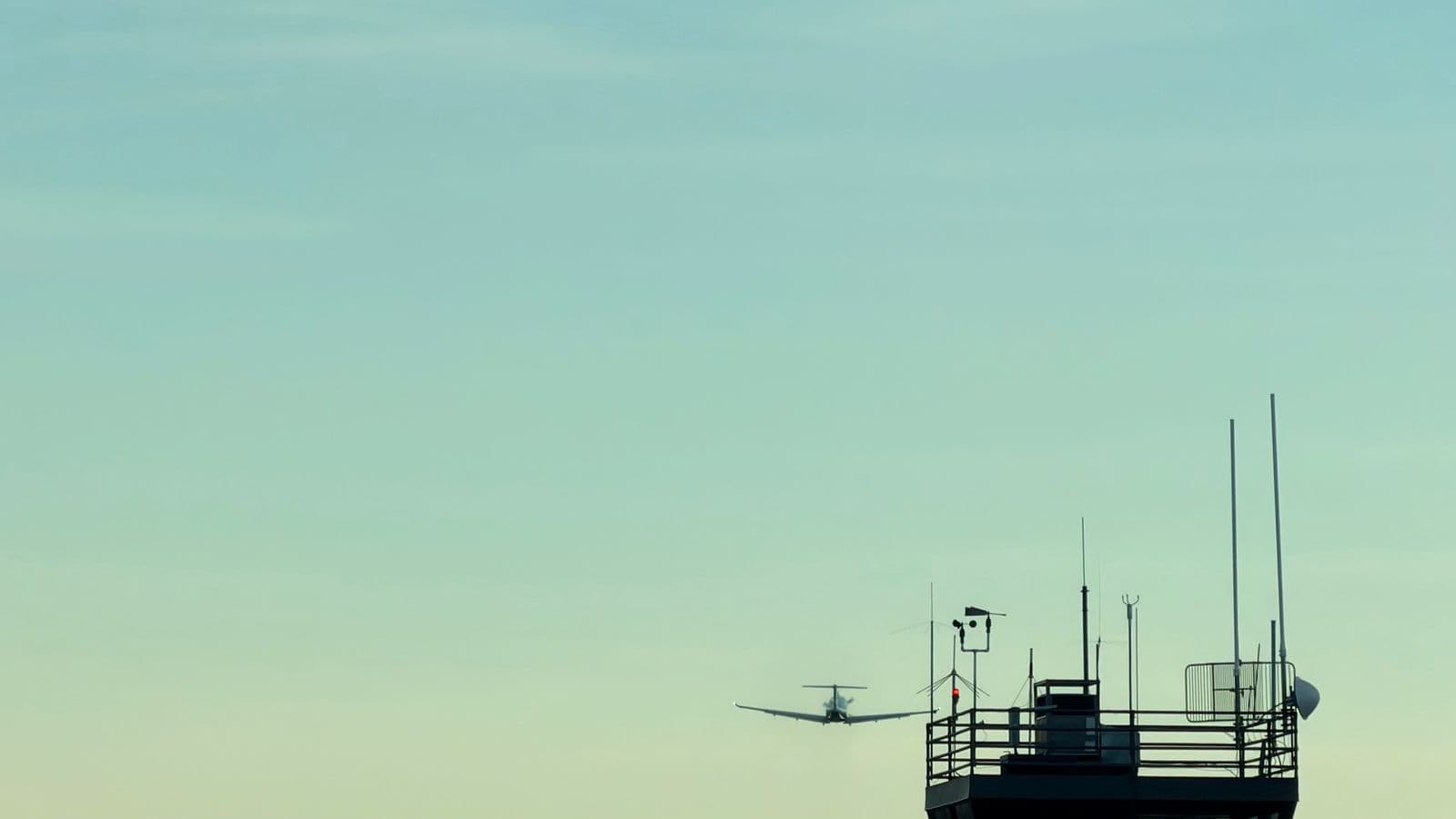 Aircraft approaching an airport control tower