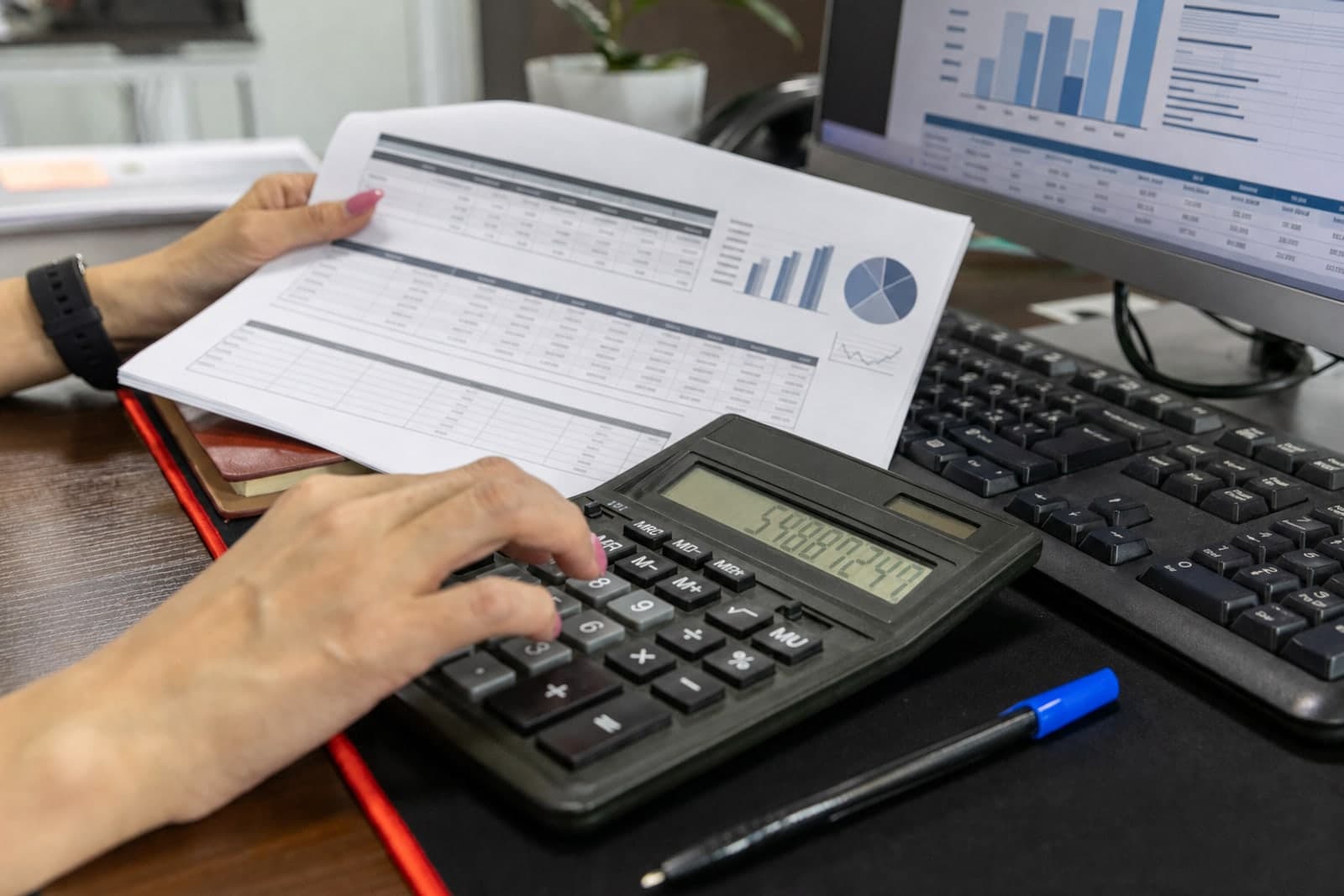 Financial documents and calculator on an office desk