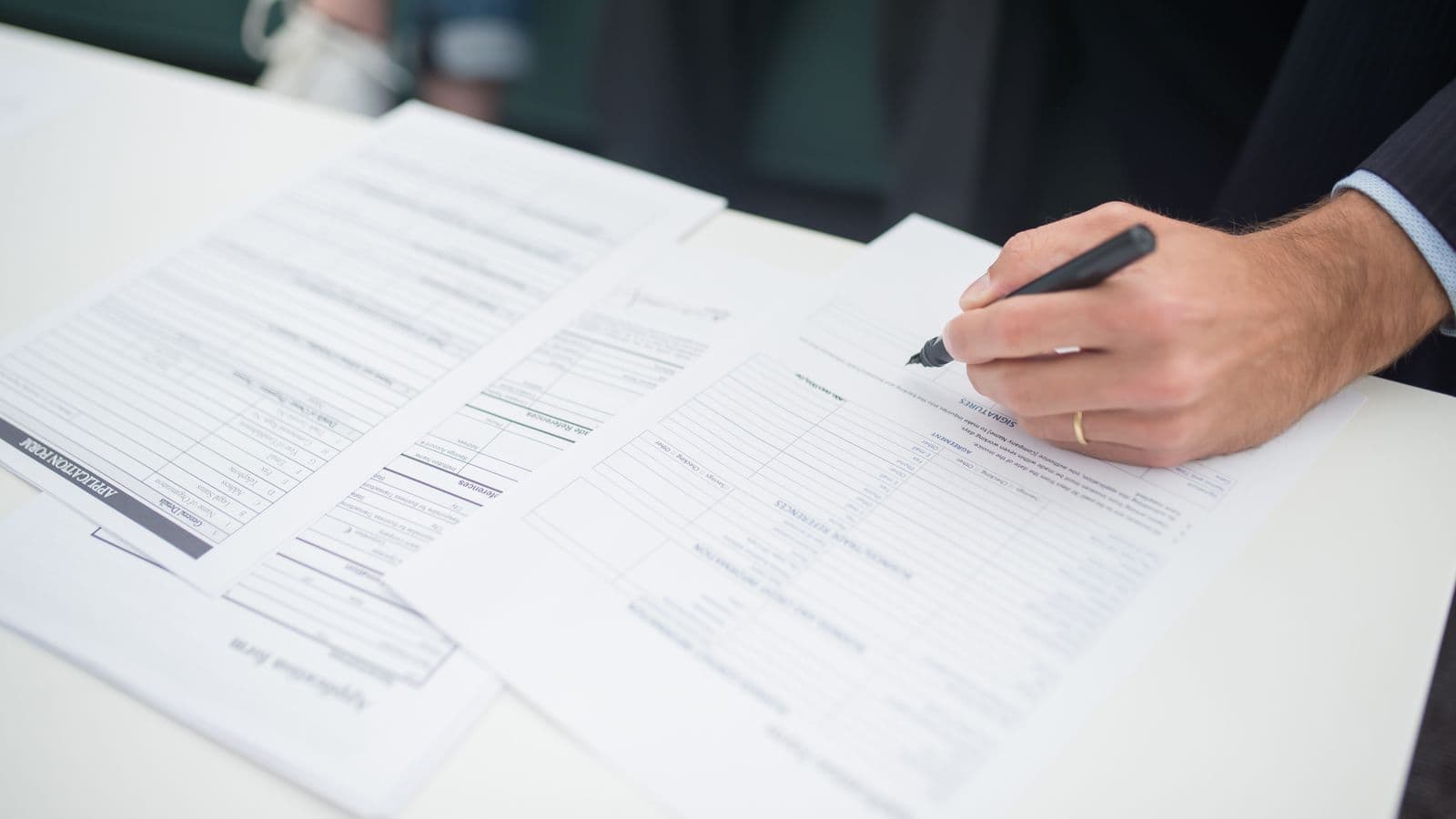 Hand completing professional employment documents